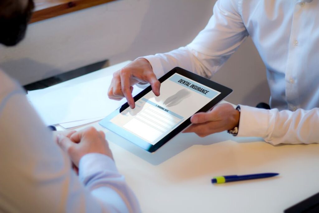 A person reviewing a dental insurance policy on an iPad.